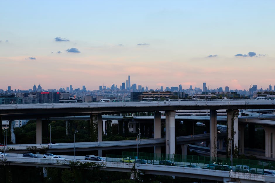 A multi-level highway overlooking a distant city skyline at dusk, capturing urban life.