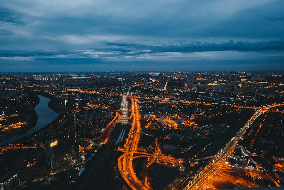 A breathtaking aerial view of a city's illuminated streets and skyline at night.