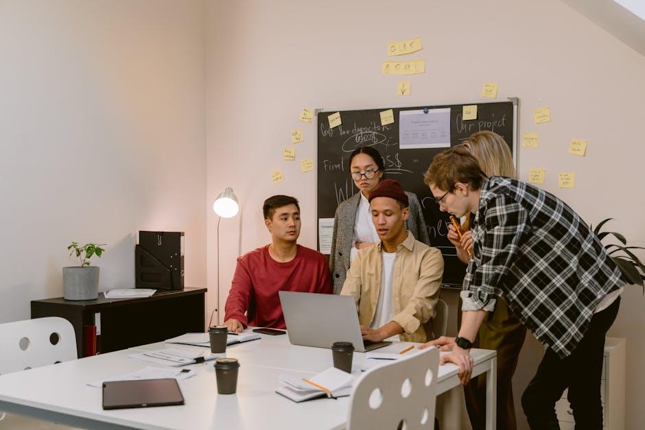 Group of young professionals brainstorming ideas in a collaborative office environment.